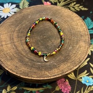 Colorful handmade bracelet with petite moon charm.
